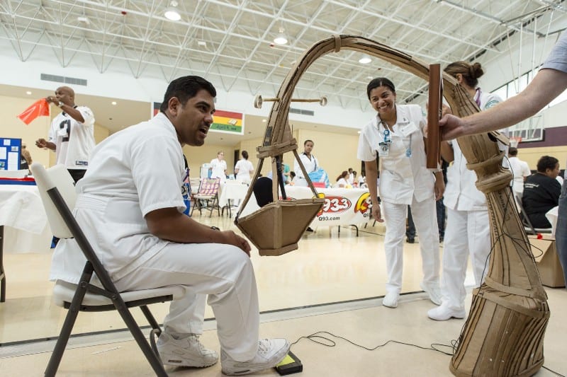 At a health fair, a health worker sits in front of a mic hidden in a basket