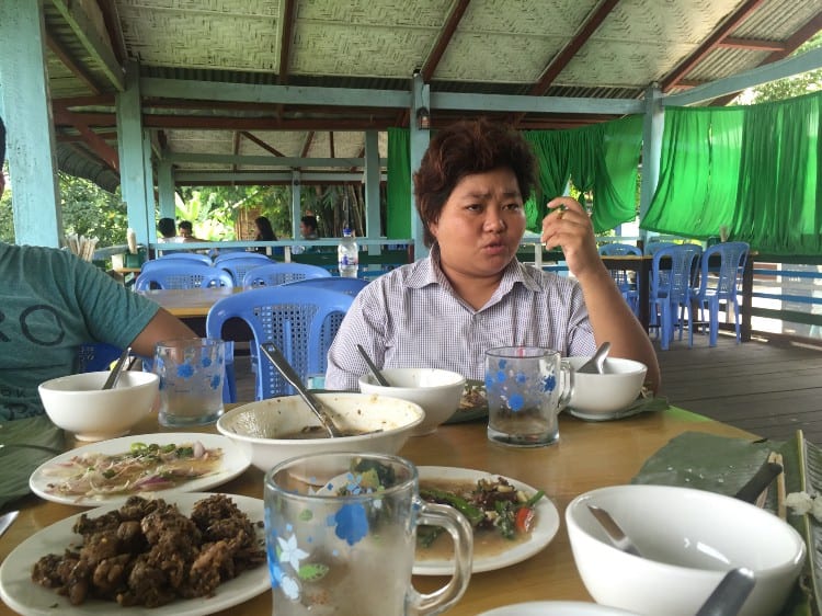 Seng Mai talks as she sits at a table after a meal