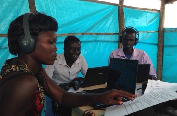 Team members work in the radio studio