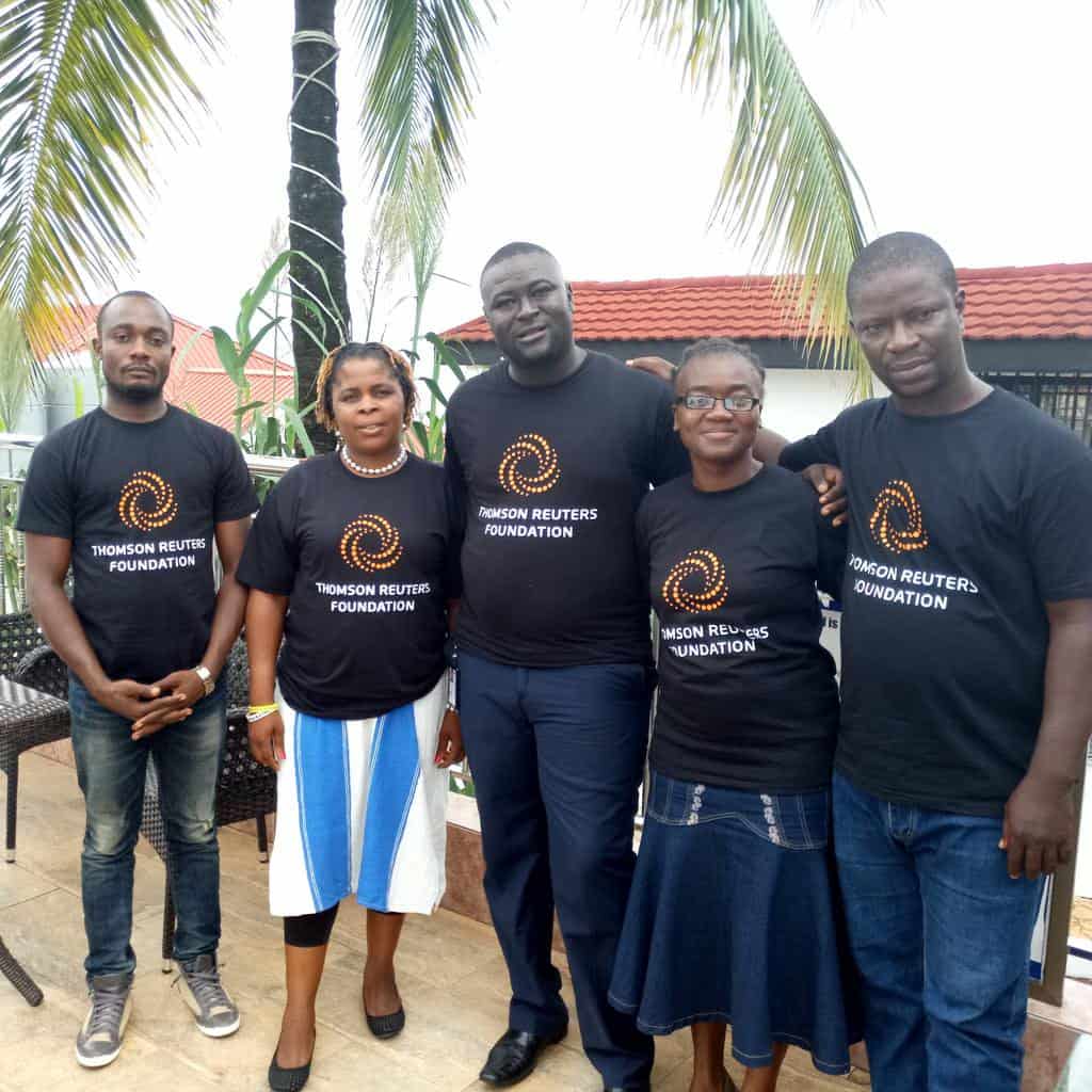Five reporters stand together, all wearing t-shirts that say Thomson Reuters Foundation