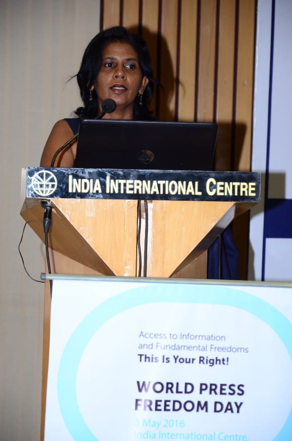 Dilrukshi stands at a podium giving a speech