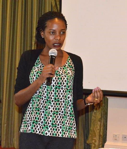 Dinah Kituyi speaking into a mic