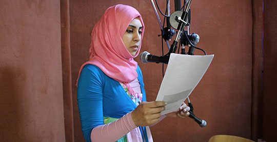 Woman in Libya recording a radio segment