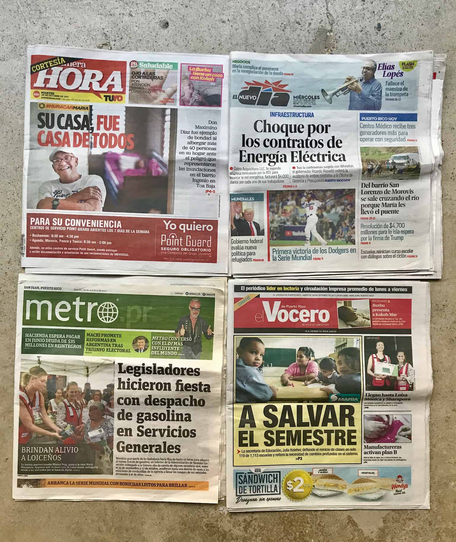 The front pages of 4 newspapers are tacked on a wall