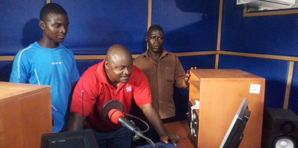 Three men work in a radio studio