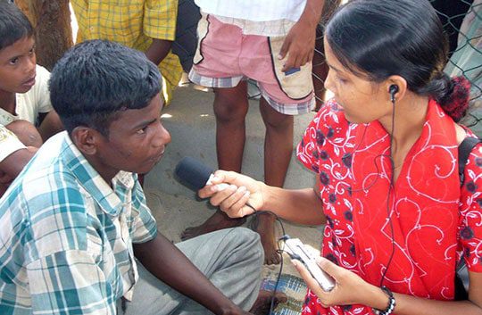Woman interviewing a man in Sri Lanka