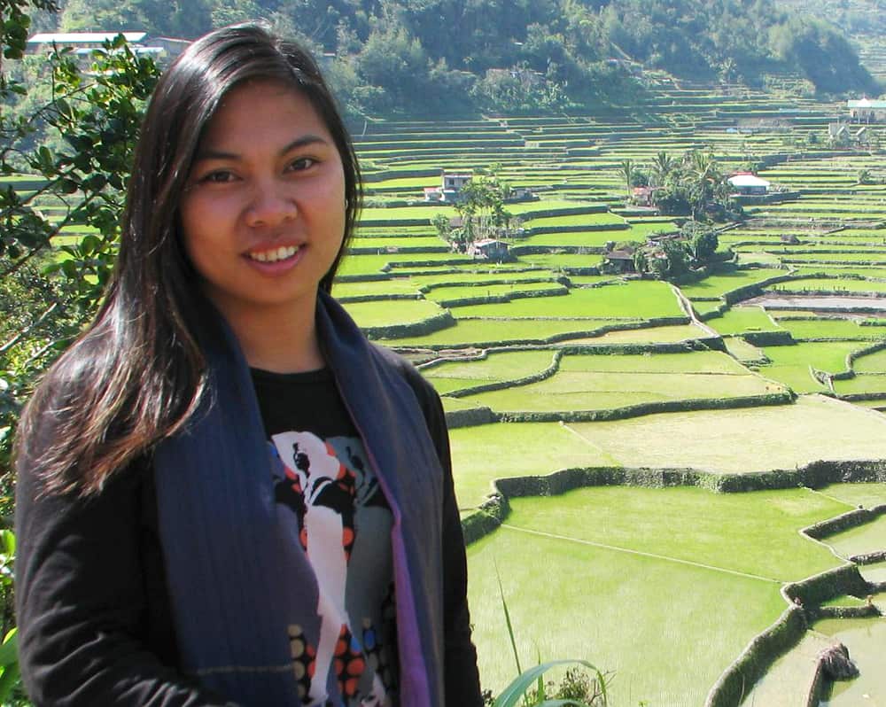 Imelda Abano with terraced farms in the background