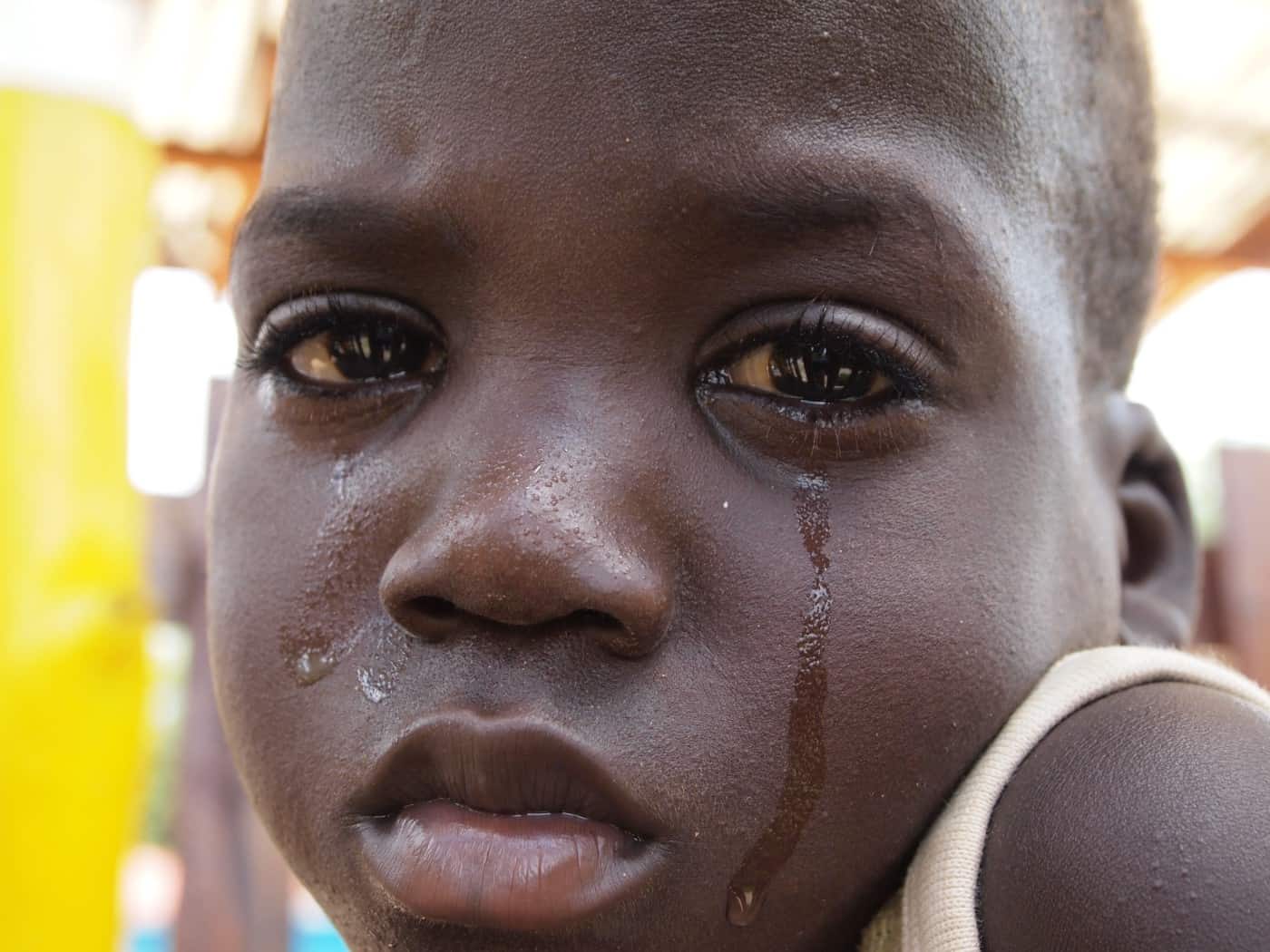 Closeup of a child's face with tears running down 
