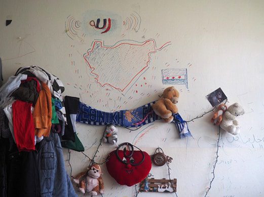 Stuffed animals are attached to a wall