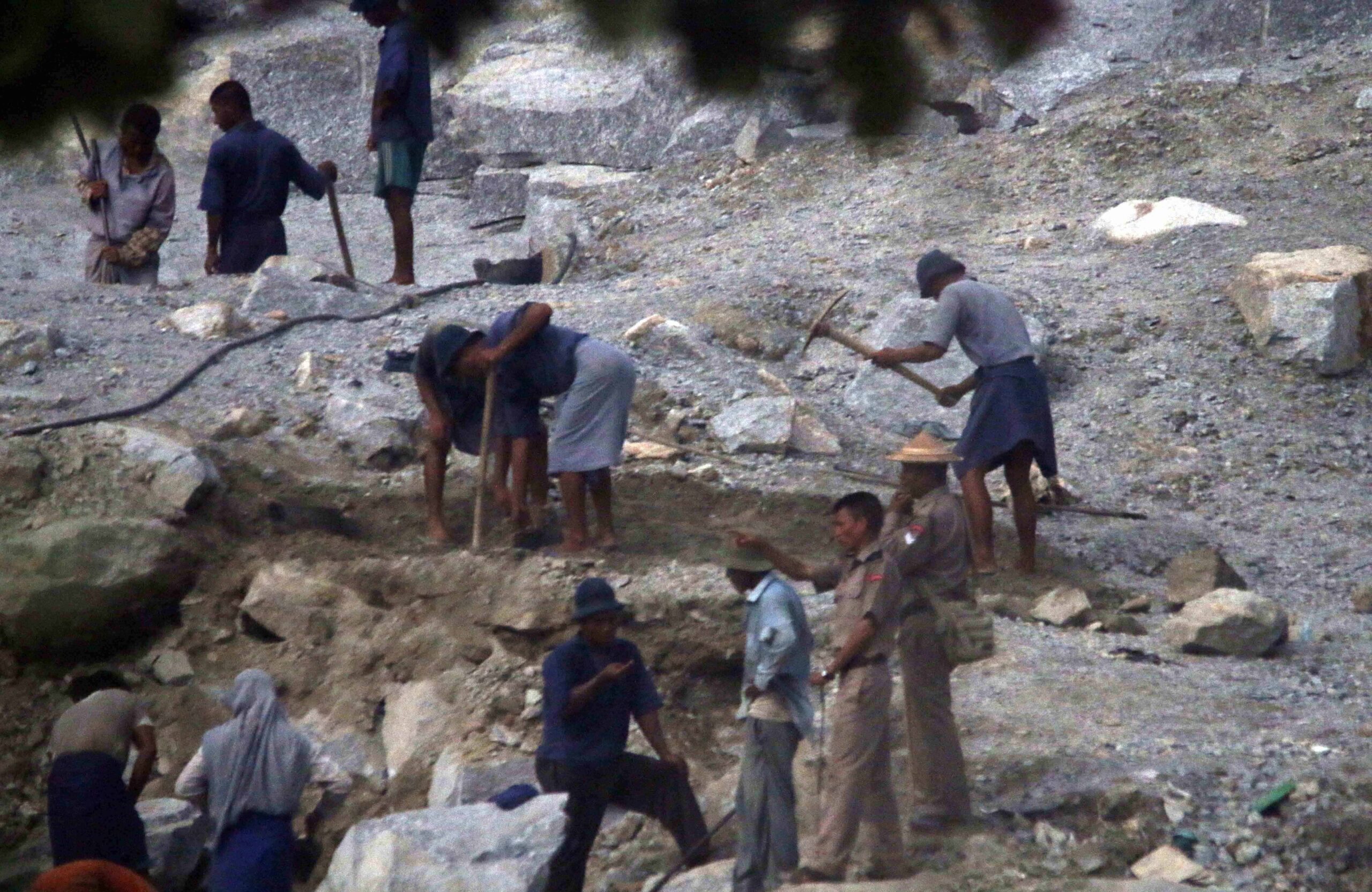 Prision laborers break rock in a quarry