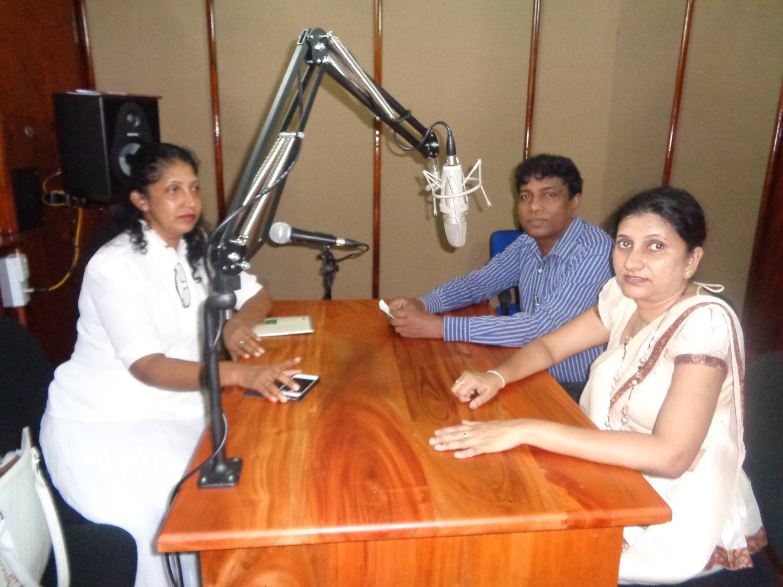 Manique and two other women in a radio studio