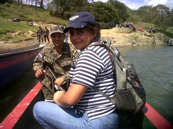 Xiomara sits in a boat with a man