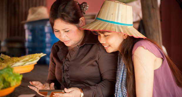 Two women look at a tablet