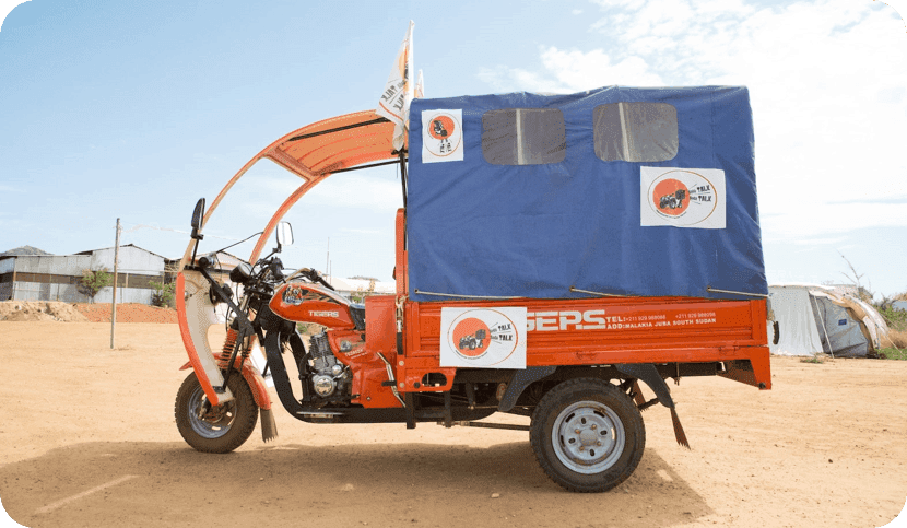 Boda Boda - a three wheeled vehicle painted orange and blue