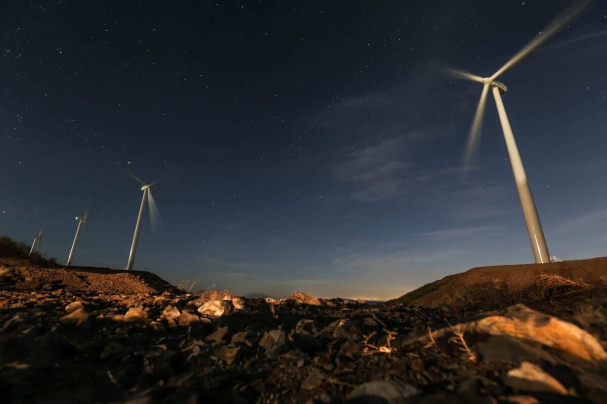 Wind turbines against a dark sky.