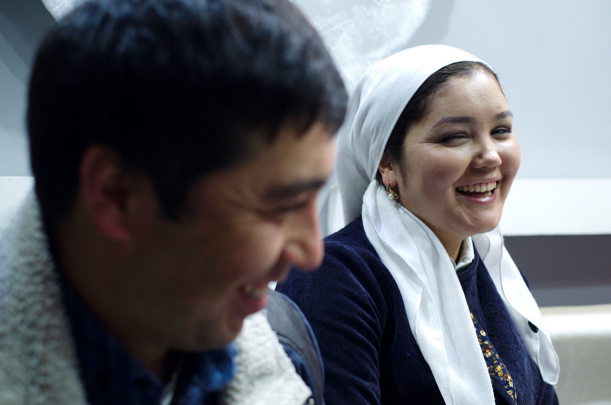 A man and a woman next to each other, both smiling