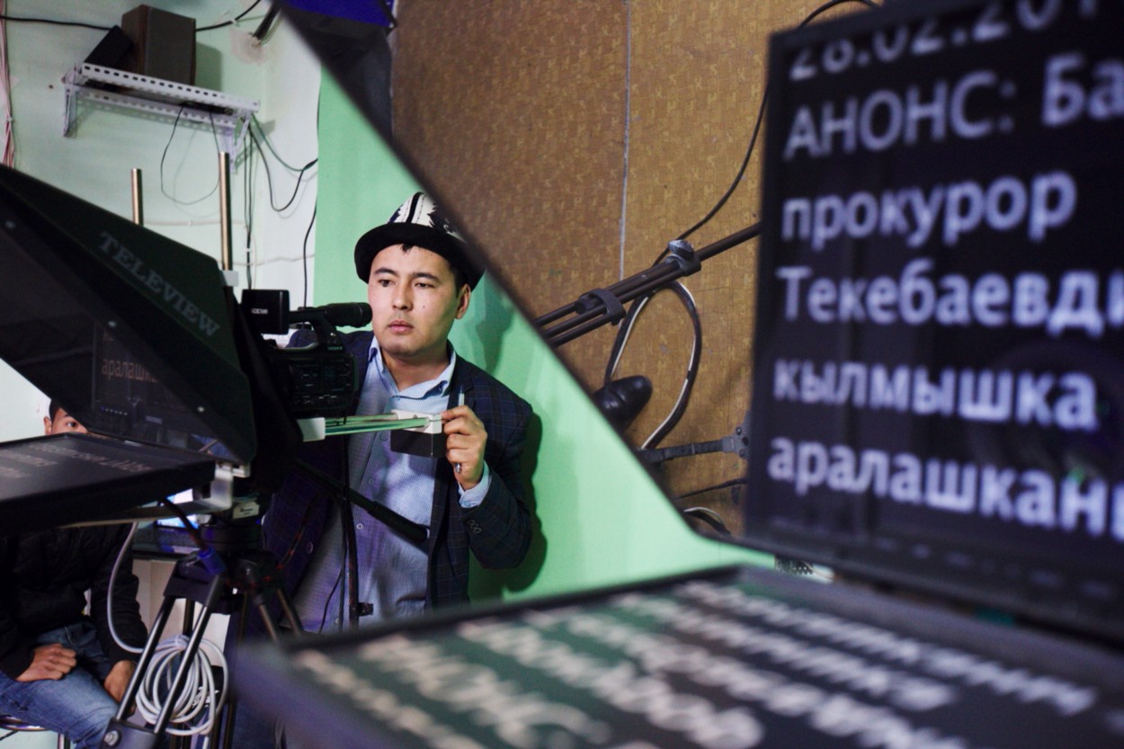 A man looks through a video camera