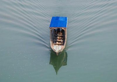 a boat floats on the river