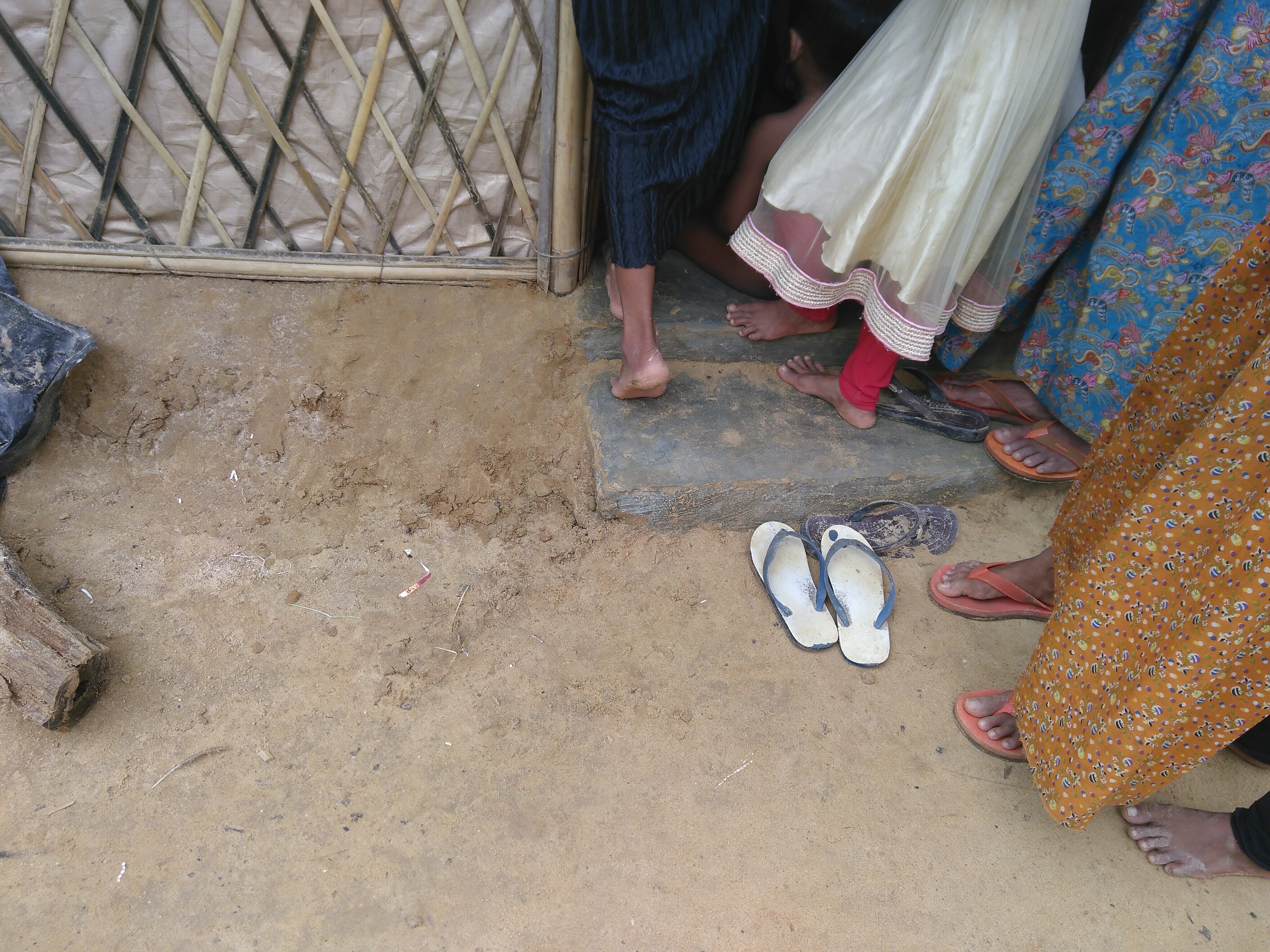 Women stand outside the door to a shelter