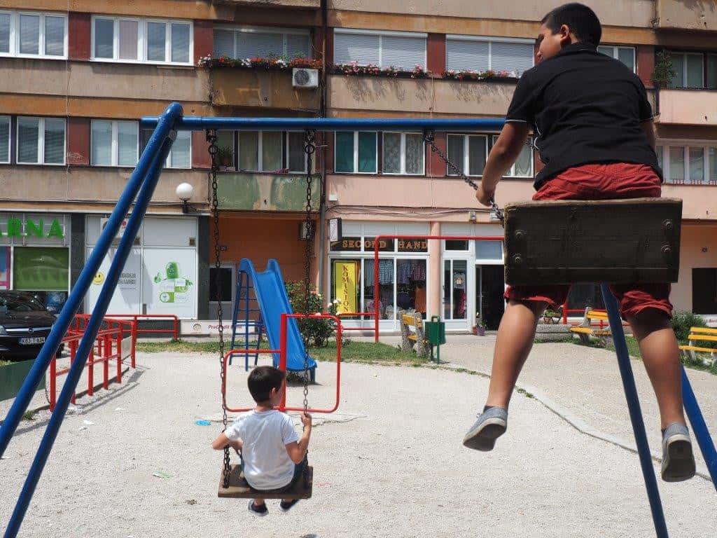 Children on swings in a playground.
