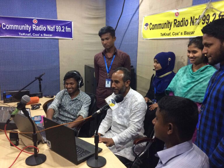 A group of people in a radio studio.