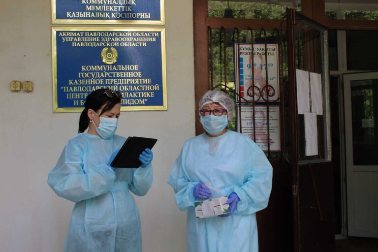 Two women in full PPE.