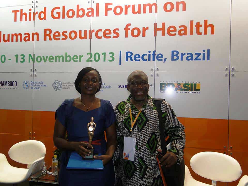 Two people seated on a stage with a banner behind them: Third Global Forum on Human Resources for Health.