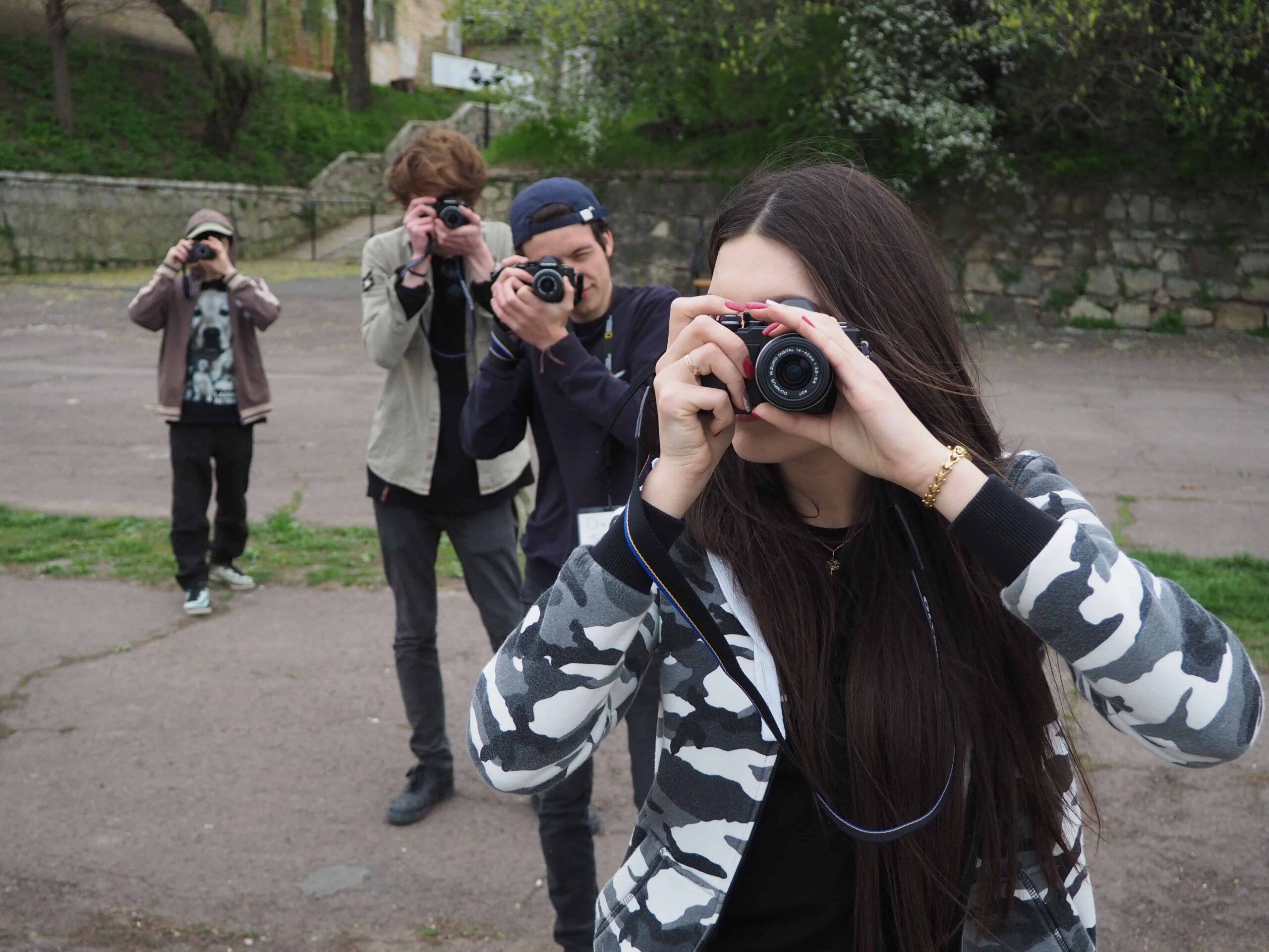 Young people using cameras.
