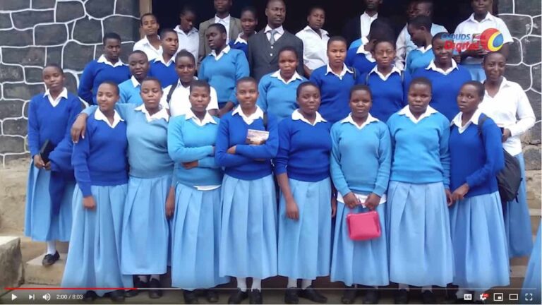 A group of girls in blue school uniforms.