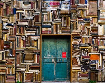A door surrounded by bookshelves.